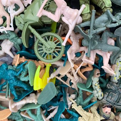 Box full of plastic toy soldiers