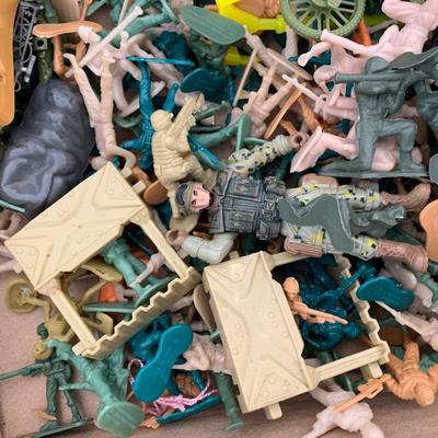 Box full of plastic toy soldiers