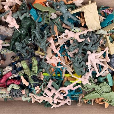 Box full of plastic toy soldiers