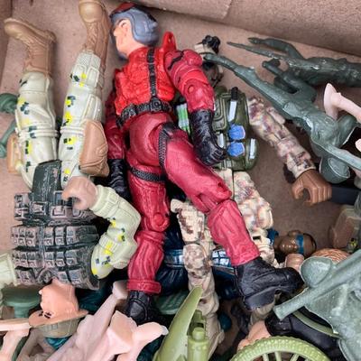 Box full of plastic toy soldiers