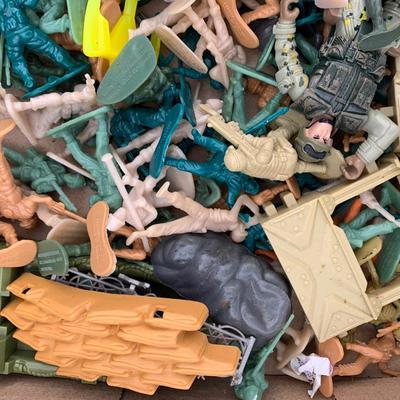 Box full of plastic toy soldiers
