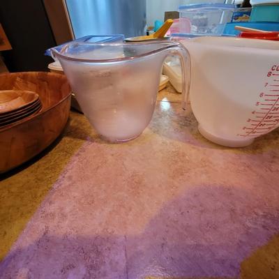 Lot of containers and measuring bowls and wooden bols serving bowl