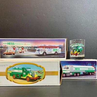 LOT:164: Collection of 3 Hess Trucks and a Collectable Hess Truck Glass - Featuring the Hess First Truck