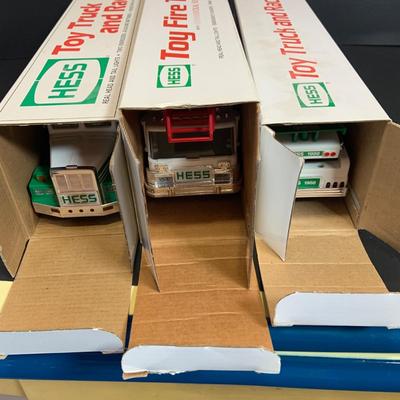 LOT:165: Assortment of 5 Hess Toy Trucks - 1989 Truck and Racer, 1989 Fire Truck. 1991 Truck and Racer, 1992 18 Wheeler and 1993 Patrol Car