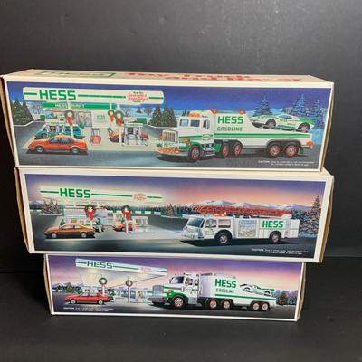 LOT:165: Assortment of 5 Hess Toy Trucks - 1989 Truck and Racer, 1989 Fire Truck. 1991 Truck and Racer, 1992 18 Wheeler and 1993 Patrol Car