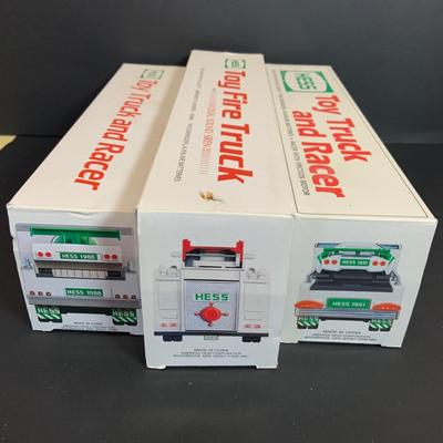 LOT:165: Assortment of 5 Hess Toy Trucks - 1989 Truck and Racer, 1989 Fire Truck. 1991 Truck and Racer, 1992 18 Wheeler and 1993 Patrol Car