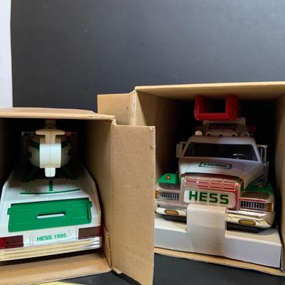 LOT:166: Collection of 5 Hess Trucks - 1994 Rescue Truck, 1995 Truck with Helicopter, 1996 Emergency Truck, 1997 Truck with Racer and...