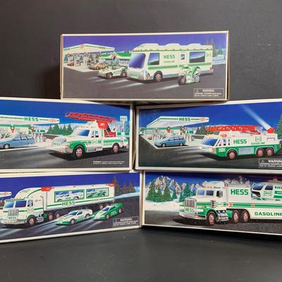 LOT:166: Collection of 5 Hess Trucks - 1994 Rescue Truck, 1995 Truck with Helicopter, 1996 Emergency Truck, 1997 Truck with Racer and...