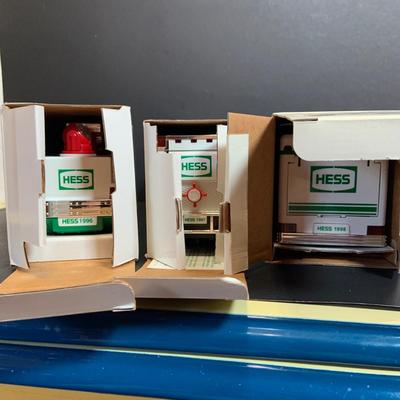 LOT:166: Collection of 5 Hess Trucks - 1994 Rescue Truck, 1995 Truck with Helicopter, 1996 Emergency Truck, 1997 Truck with Racer and...