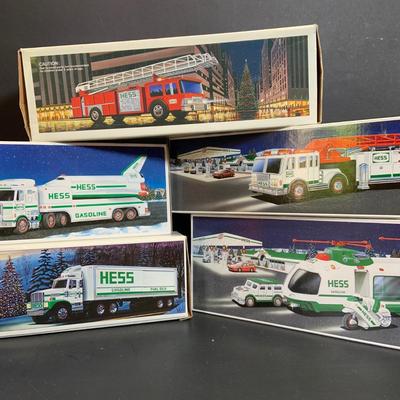 LOT:167: Assortment of 5 Hess Toy Trucks Featuring 1986 Toy Fire Truck and 1987 Toy Truck Bank with Barrels, 1999 Truck and Space...