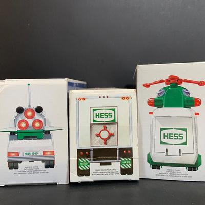LOT:167: Assortment of 5 Hess Toy Trucks Featuring 1986 Toy Fire Truck and 1987 Toy Truck Bank with Barrels, 1999 Truck and Space...