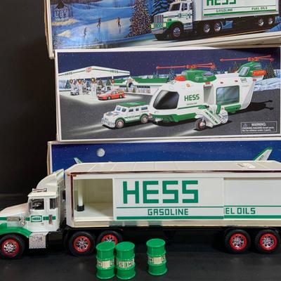 LOT:167: Assortment of 5 Hess Toy Trucks Featuring 1986 Toy Fire Truck and 1987 Toy Truck Bank with Barrels, 1999 Truck and Space...
