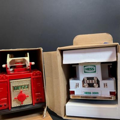 LOT:167: Assortment of 5 Hess Toy Trucks Featuring 1986 Toy Fire Truck and 1987 Toy Truck Bank with Barrels, 1999 Truck and Space...