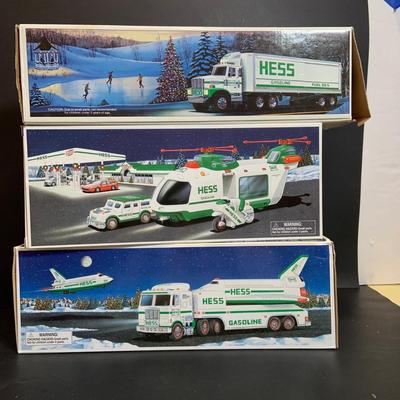 LOT:167: Assortment of 5 Hess Toy Trucks Featuring 1986 Toy Fire Truck and 1987 Toy Truck Bank with Barrels, 1999 Truck and Space...