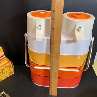 LOT:180: Mid-Century Orange Kitchen Including a Peacock Hot/Cold Twin Air Pot Vacuum Thermos, 70' Style Drinking Glasses and Napkin...