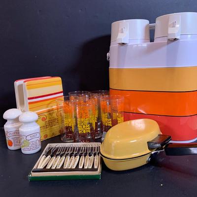 LOT:180: Mid-Century Orange Kitchen Including a Peacock Hot/Cold Twin Air Pot Vacuum Thermos, 70' Style Drinking Glasses and Napkin...
