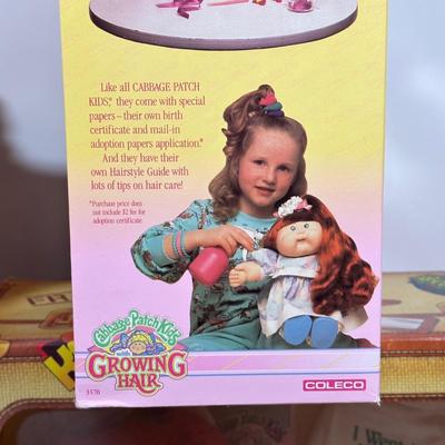 LOT 164: Cabbage Patch Kids Collection - World Traveler, Growing Hair & Young Astronaut in Box