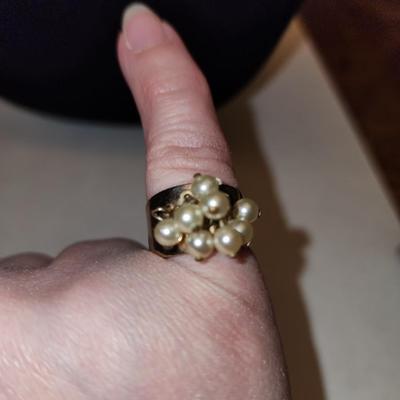 Gold tone ring with cultured freshwater pearls.