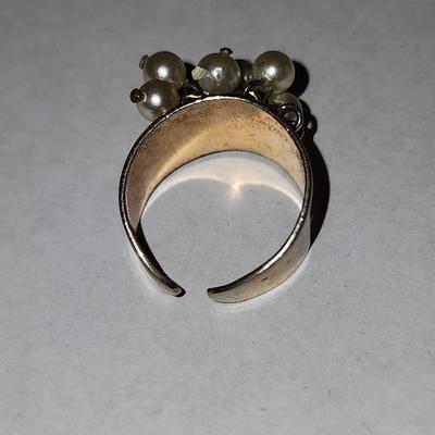 Gold tone ring with cultured freshwater pearls.