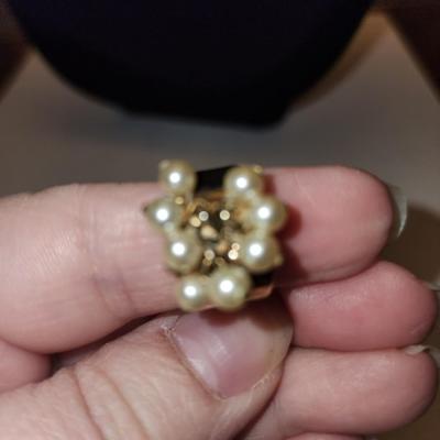 Gold tone ring with cultured freshwater pearls.