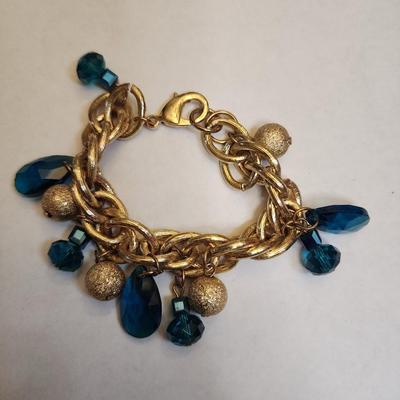 Gone tone heavy bracelet with teal jewels