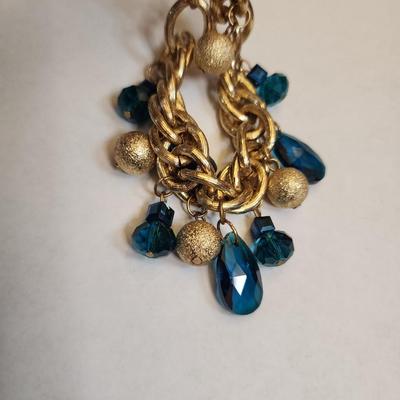 Gone tone heavy bracelet with teal jewels