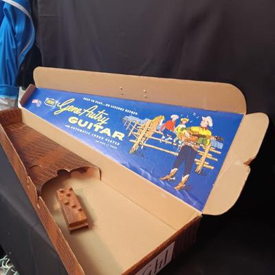 1955 CHILD'S GENE AUTRY BAKELITE GUITAR WITH RAISED DECORATION ON FACE
