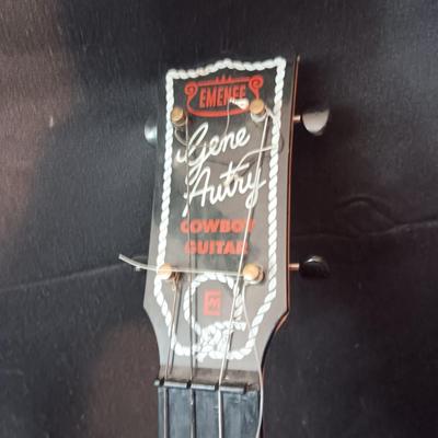 1955 CHILD'S GENE AUTRY BAKELITE GUITAR WITH RAISED DECORATION ON FACE