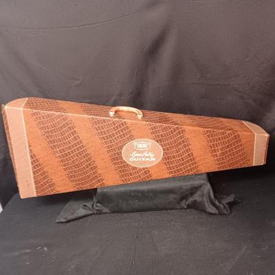 1955 CHILD'S GENE AUTRY BAKELITE GUITAR WITH RAISED DECORATION ON FACE