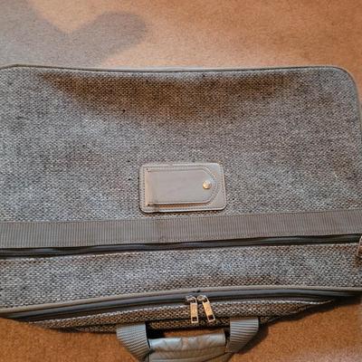 Collection of ceramics in a vintage Samsonite carry on bag