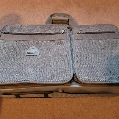 Collection of ceramics in a vintage Samsonite carry on bag