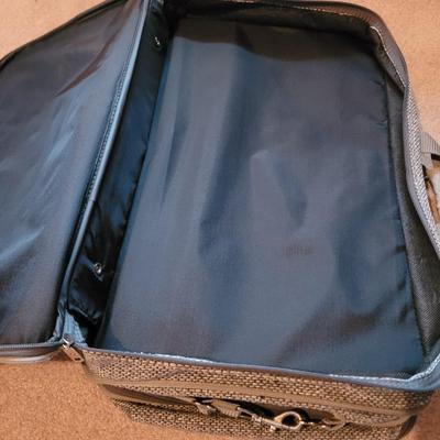 Collection of ceramics in a vintage Samsonite carry on bag