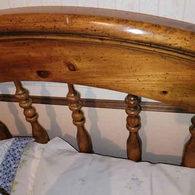 Mid century wooden queen sized bed with handmade quilt