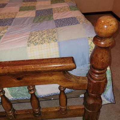 Mid century wooden queen sized bed with handmade quilt