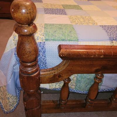 Mid century wooden queen sized bed with handmade quilt