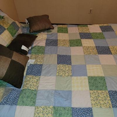 Mid century wooden queen sized bed with handmade quilt