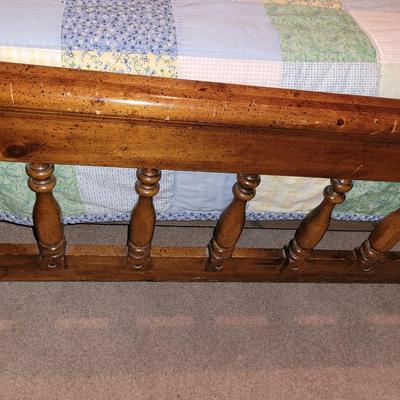 Mid century wooden queen sized bed with handmade quilt