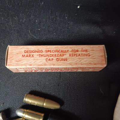TOY BRASS AND PLASTIC BULLETS AND A BOX OF THUNDERCAPS