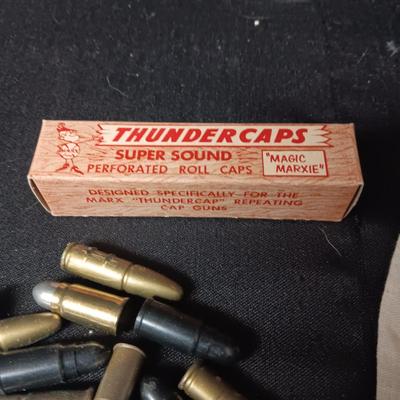 TOY BRASS AND PLASTIC BULLETS AND A BOX OF THUNDERCAPS