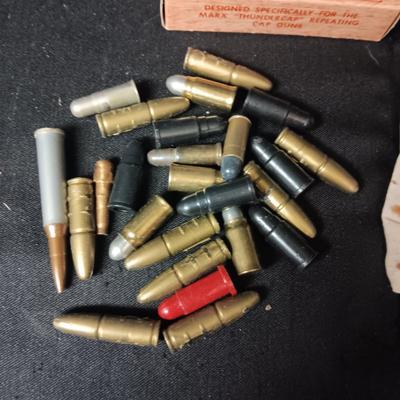 TOY BRASS AND PLASTIC BULLETS AND A BOX OF THUNDERCAPS