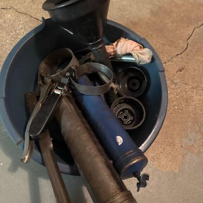 Plastic oil pan, two grease guns two oil filter wrenches and a funnel