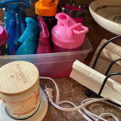 Spray bottles and mugs with candle, warmer and decorative bowl