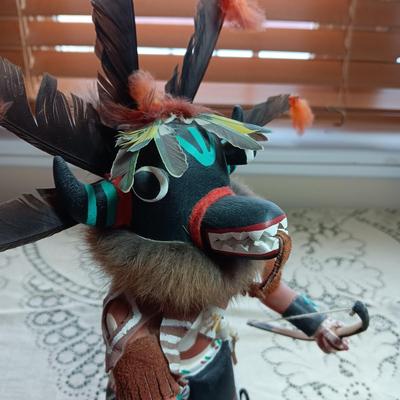 KACHINA DOLL HAND CARVED & PAINTED W/FUR & FEATHERS WIELDING A HAND SAW