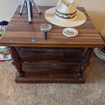 Side table, flashlight, magnifying glass, coaster, and a hat