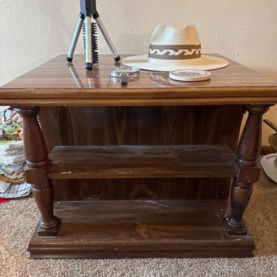Side table, flashlight, magnifying glass, coaster, and a hat