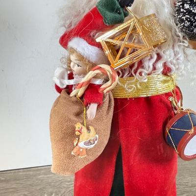 LOT 55M: Byer's Choice - 2012 Santa w/ Toys, 2006 Fireplace w/ Music Stand & A Christmas Carol Puzzle
