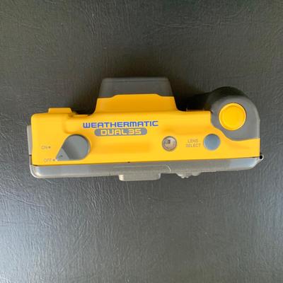 LOT 104 M: Minolta Underwater Cameras w/ Cases: Weathermatic Dual 35 Model #02354983 & Weathermatic A 110 Model #1040685