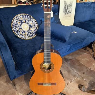 Sale Photo Thumbnail #102: The Suzuki Model No 38 is a classical guitar crafted in Japan using high-quality tonewoods. It comes with a hard case for protection. Suitable for performances, practice sessions, or casual playing. This guitar is pre-owned.