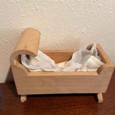 Small trolls, wooden cradle and golf cart
