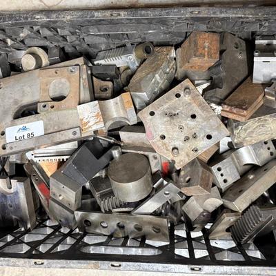 Black crate of various steel pieces